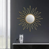 Gold sunburst wall mirror with round center and pointed rays"